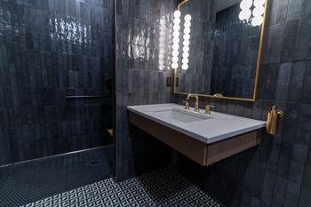 A bathroom with a sink and a mirror.